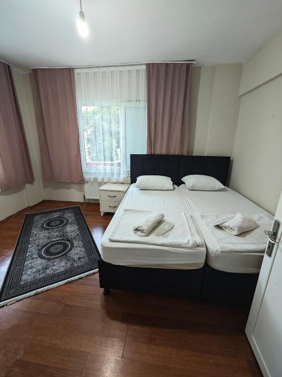 Postel nebo postele na pokoji v ubytování Dunya Pansiyon