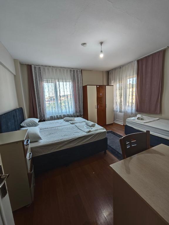 Postel nebo postele na pokoji v ubytování Dunya Pansiyon