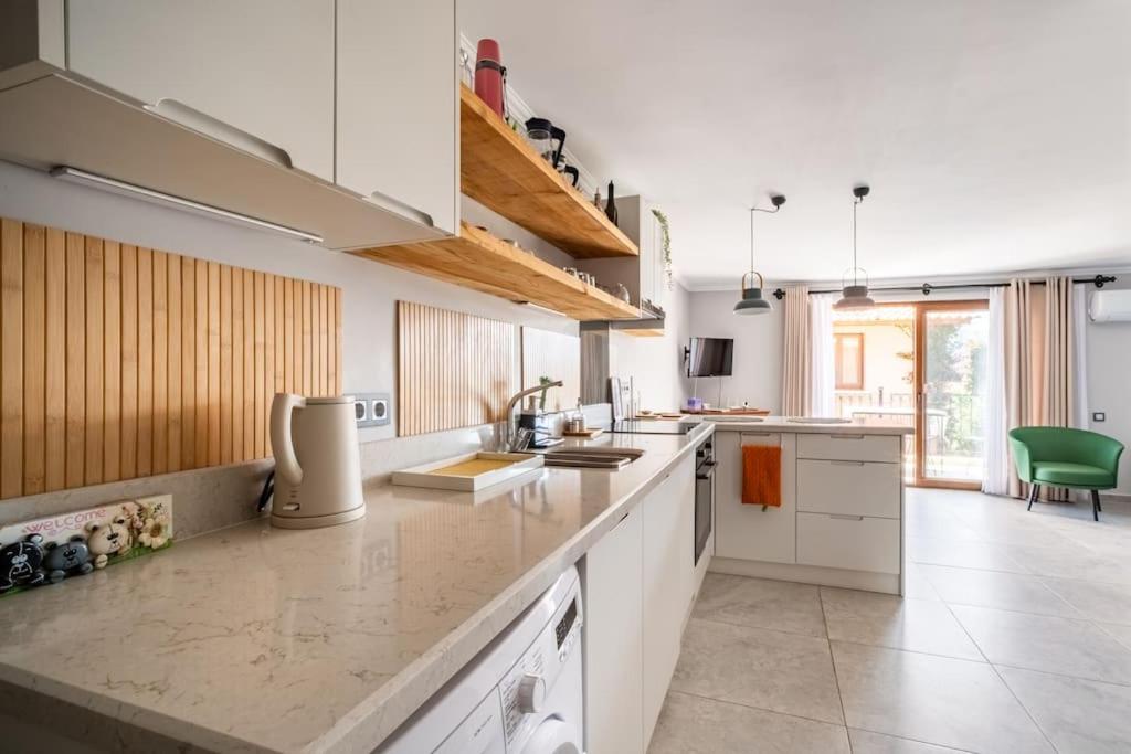 a kitchen with white cabinets and a counter top at Kalkan lovely 1 bedroom holiday rental in Kas