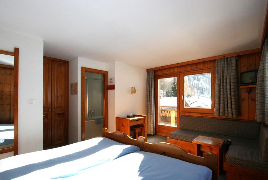 Voodi või voodid majutusasutuse Hôtel Garni Les Bouquetins toas