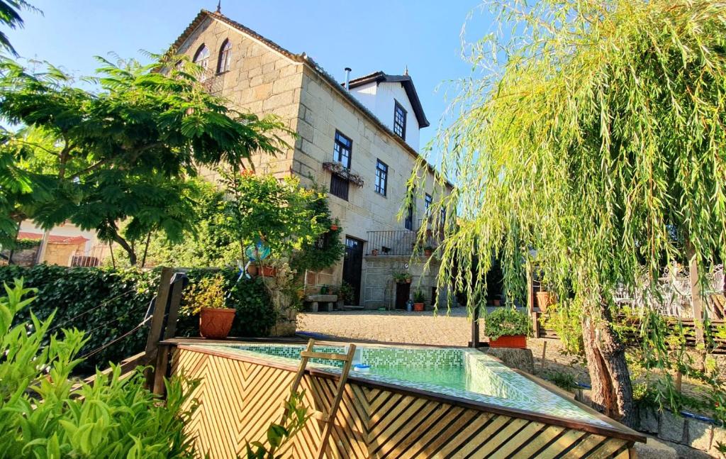 a swimming pool in the yard of a house at Casa do Fundo - Sustainable & Ecotourism in Seia