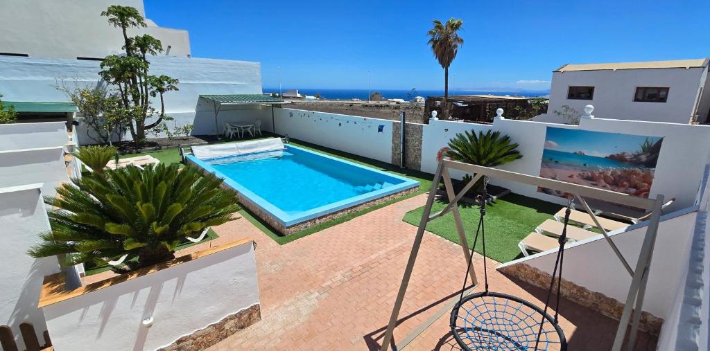 a swimming pool on the roof of a house at Direktly at our Swimming pool - Relax - Aduls only in Tías