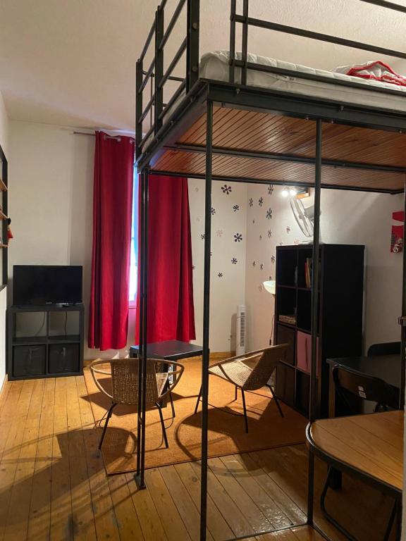 Cette chambre comprend des lits superposés, une table et des chaises. dans l'établissement Big, à Narbonne