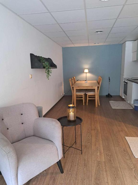 a living room with a couch and a table at Haukeli hotell leilighet in Haukeligrend