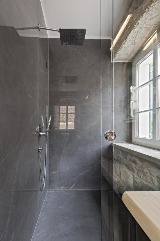 a shower with a glass door in a bathroom at NEW - Casa Columba - 4 Star Design Boutique Hotel with Outdoor Pool & Private Garden in Makarska