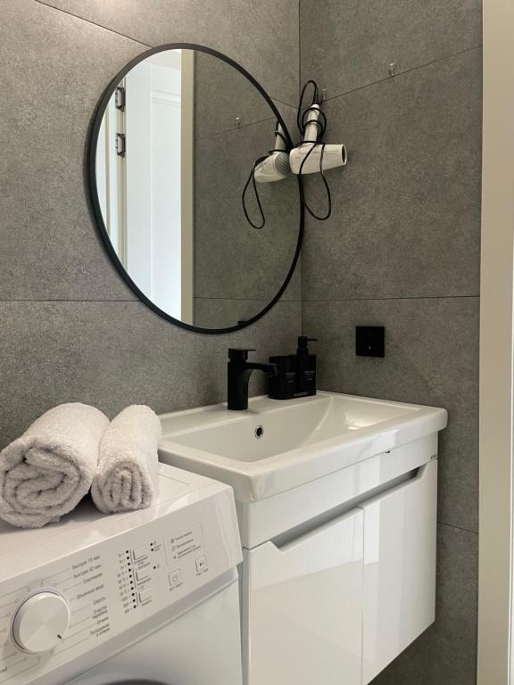 a bathroom with a sink and a mirror at Больница Управ делами президента , IT Университет, Центр репродукции, Экспо Mega Silkway, Аэропорт in Prigorodnyy