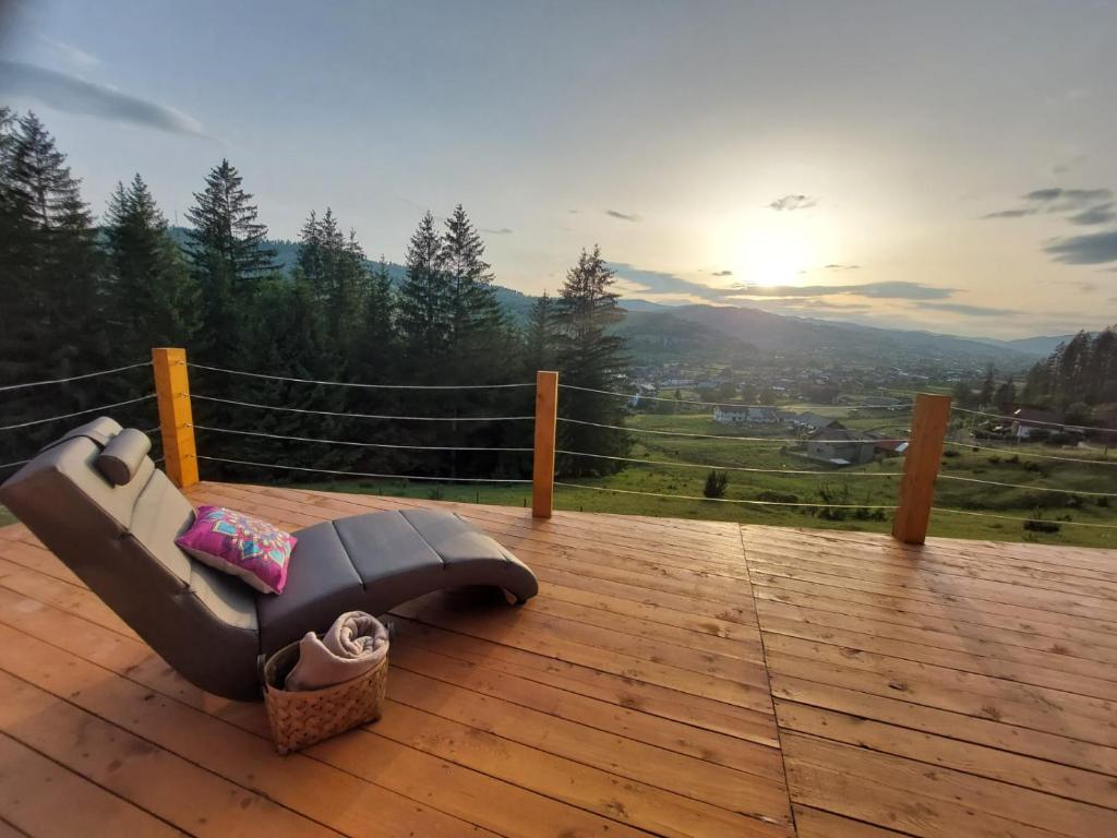 a couch sitting on top of a wooden deck at Fancy Maisonnette in Gura Humorului