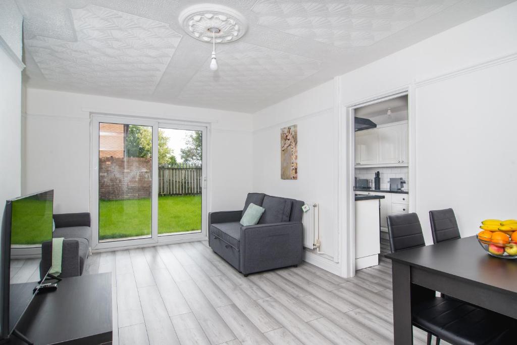 a living room with a chair and a table at Quiet 3 bed house, pet friendly in Kirkby