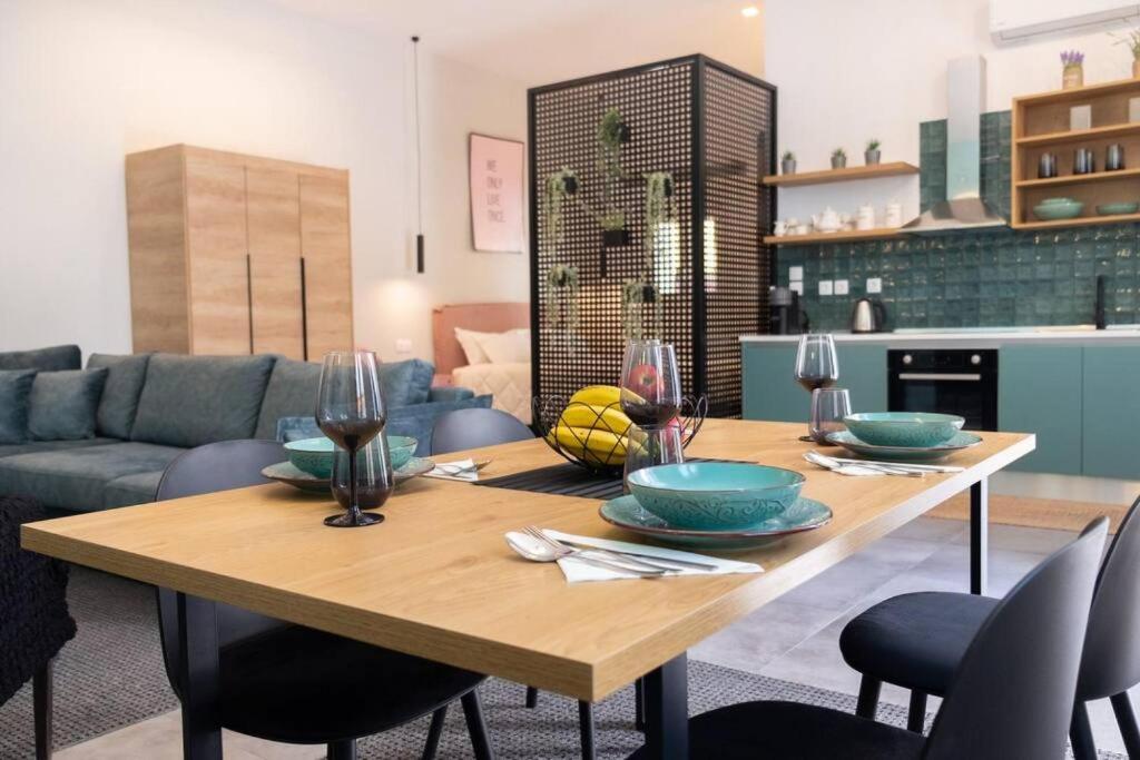 a living room with a wooden table and a couch at Casa d'oro 56 Living in Paradisi Rhodes in Paradeísion