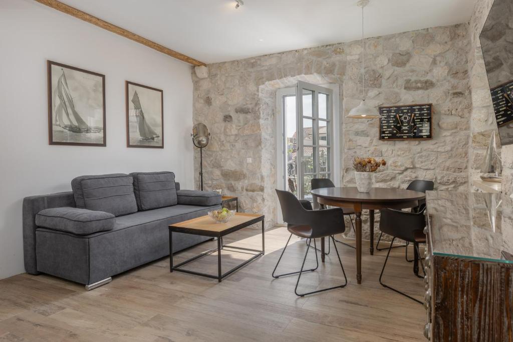 a living room with a couch and a table at NEW - Casa Columba - 4 Star Design Boutique Hotel with Outdoor Pool & Private Garden in Makarska