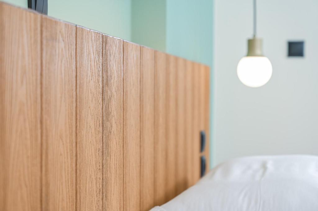 A bed or beds in a room at Emily Hotel