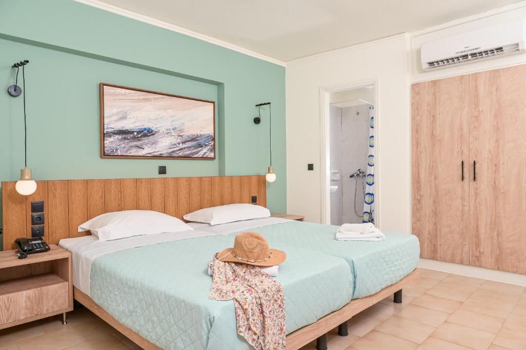 A bed or beds in a room at Emily Hotel