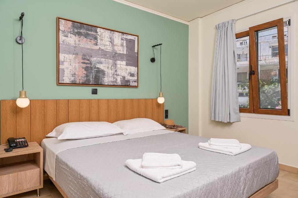 A bed or beds in a room at Emily Hotel