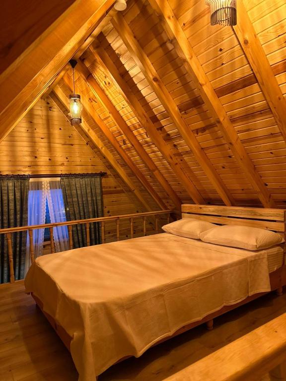 a bedroom with a large bed in a attic at YUSUF KARGI - Günübirlik Turizm VİLLA in Ordu