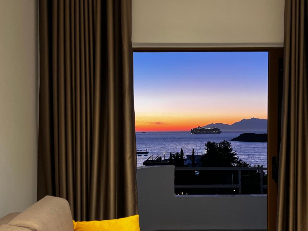 a room with a window with a view of the ocean at Dine Hotel in Ksamil