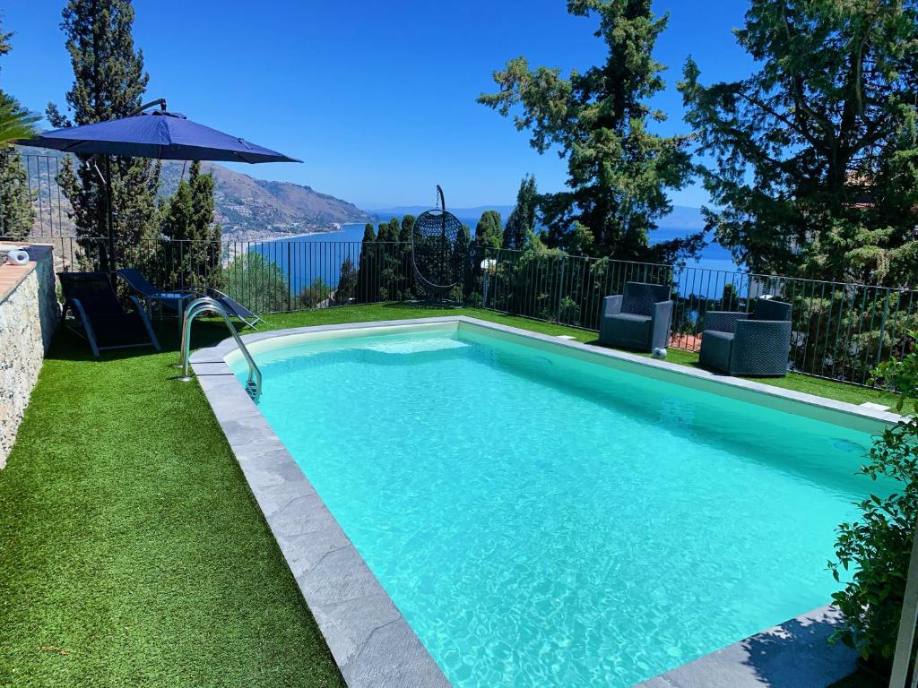 a swimming pool with a view of the water at Villa Mimma in Taormina