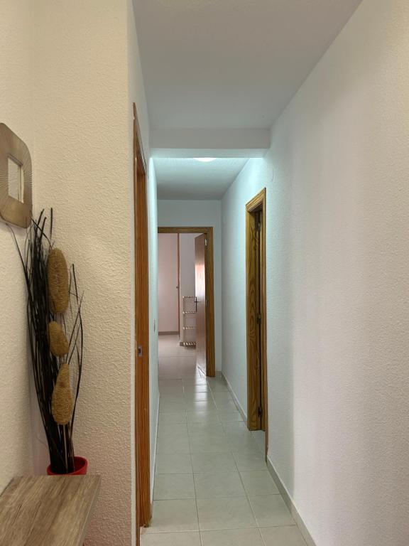 a hallway with a hallway leading to a room at La caleta in Oropesa del Mar