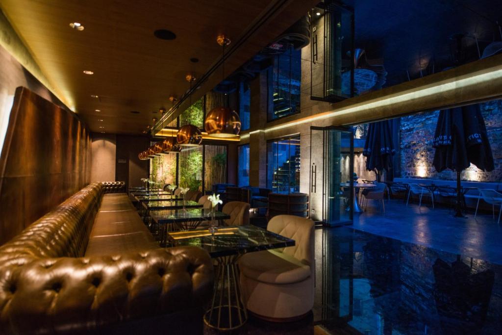 a bar with a leather couch and tables and chairs at Hotel Saint Sophia in Istanbul