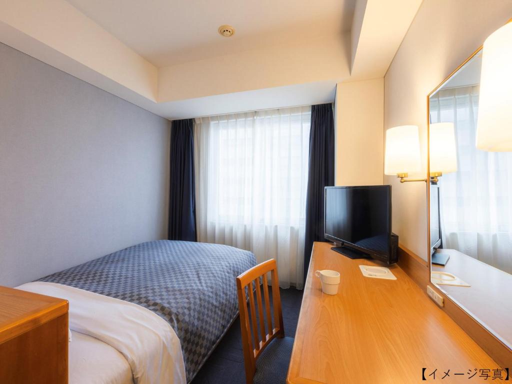 Postel nebo postele na pokoji v ubytování Yokohama Sakuragicho Washington Hotel