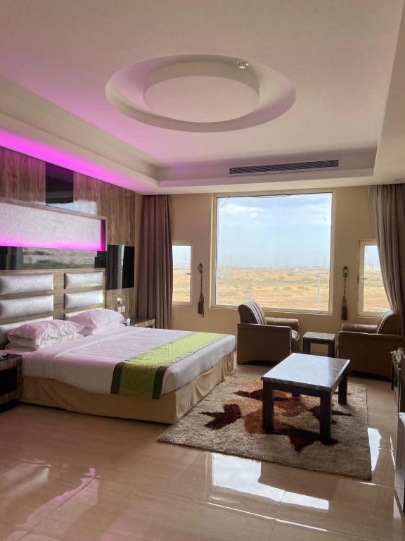 Postel nebo postele na pokoji v ubytování Al- Reef Hotel