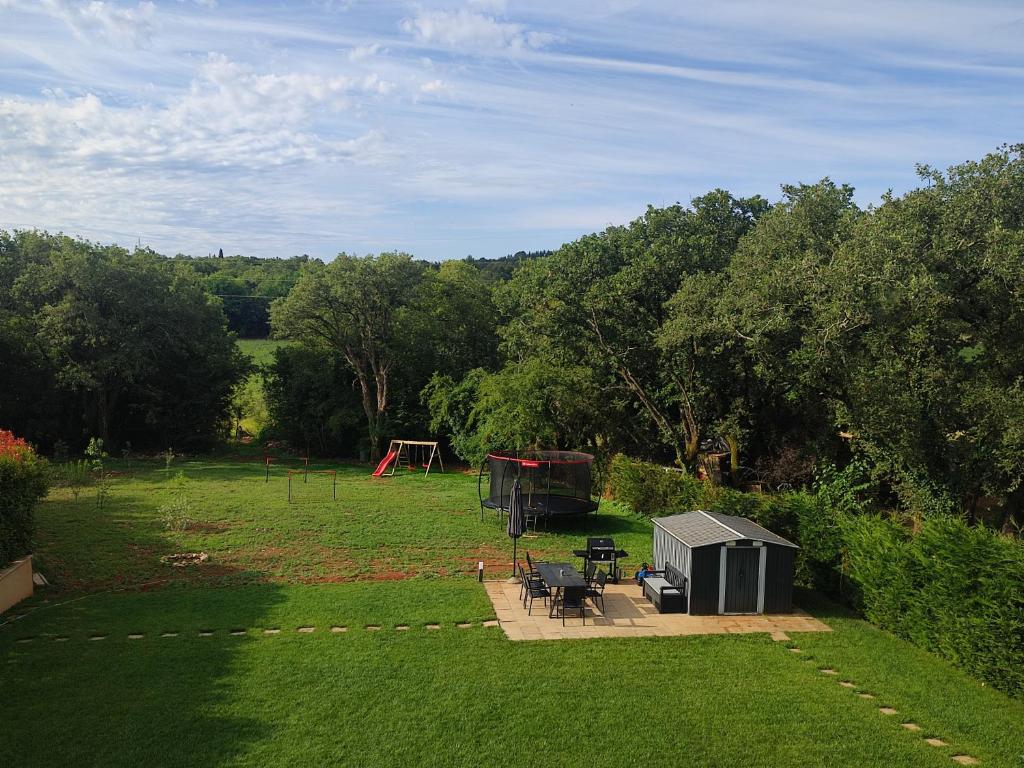 a yard with a picnic table and a playground at Apartment Aria in Poreč