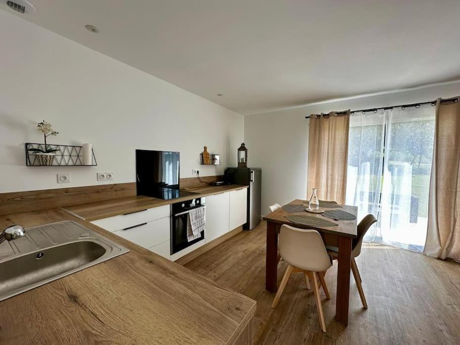 a kitchen with a table and a kitchen with a sink at Al País Del Mesturet in Graulhet