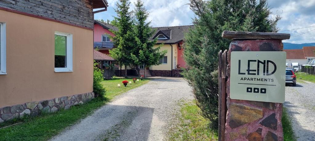 a sign on a pole in front of a house at Lend apartment in Miercurea-Ciuc