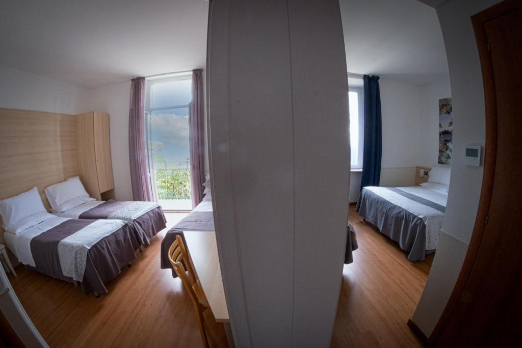 Postel nebo postele na pokoji v ubytování Hotel Vista Lago