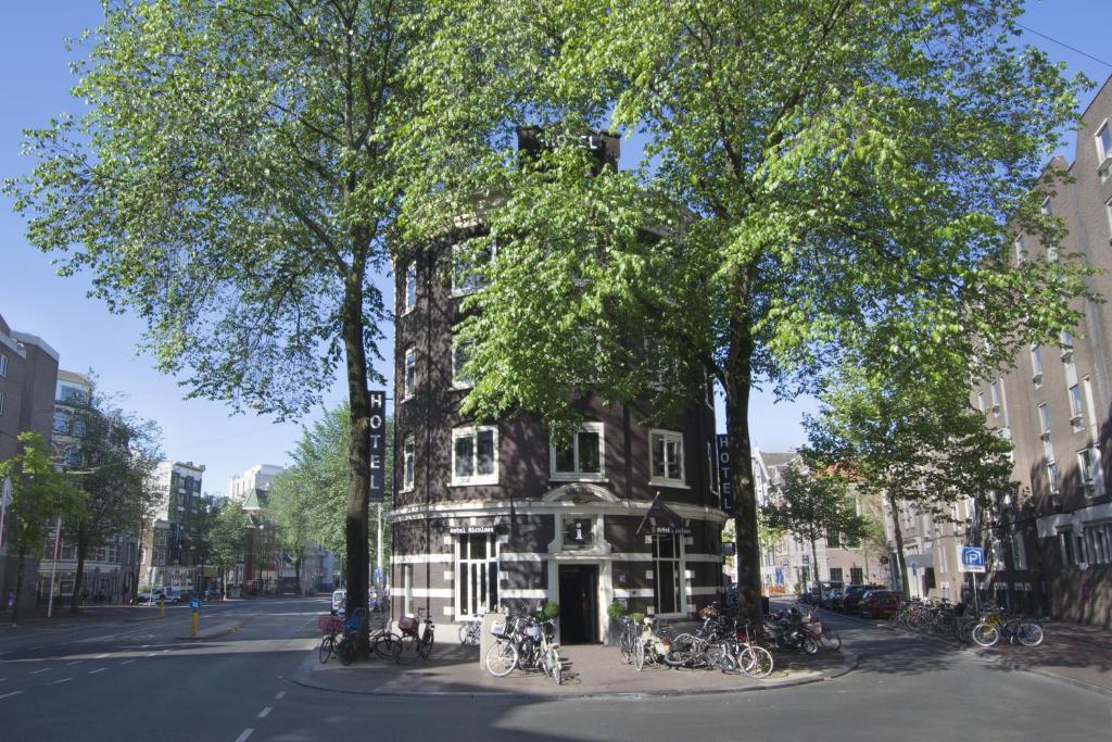 ein Gebäude mit Fahrrädern, die davor geparkt sind in der Unterkunft Hotel Sint Nicolaas in Amsterdam