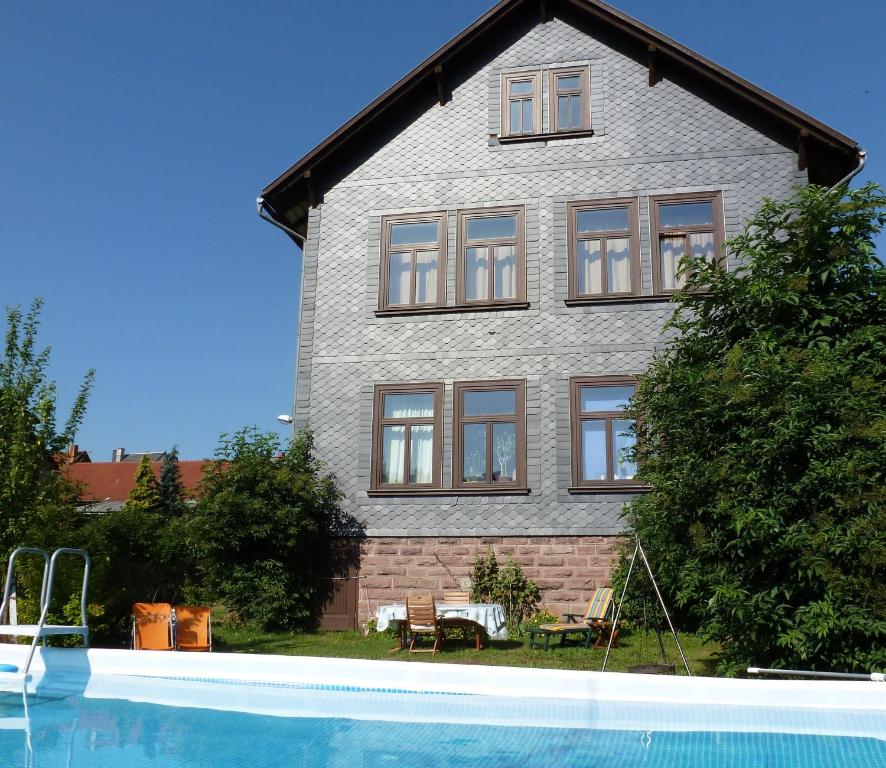 a house with a swimming pool in front of it at Alte Schule in Tambach-Dietharz