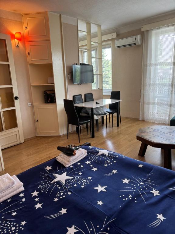 a living room with a blue blanket with stars on it at Cozy apartment with balcony in Tbilisi City