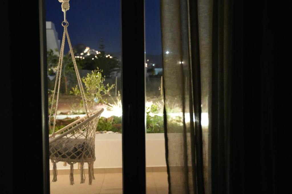 a hammock hanging from a window in a room at Pyrra apartments in Skiros