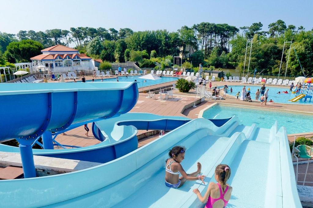 two girls on a slide at a water park at l'orée du lac in Talmont