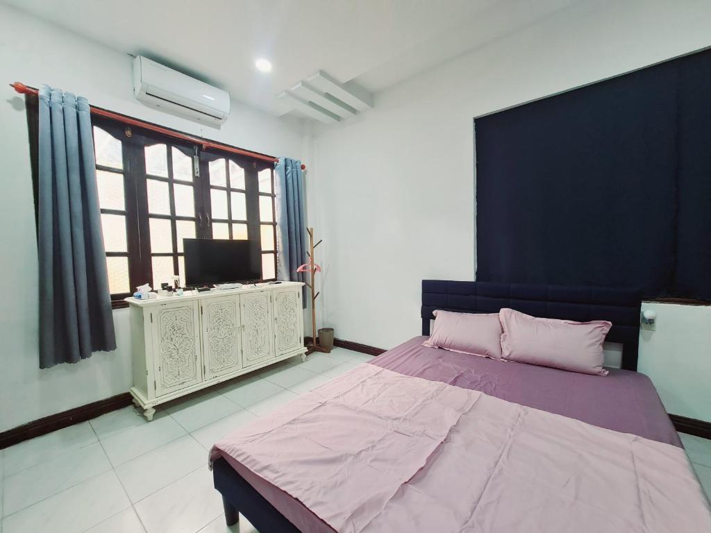 En eller flere senge i et værelse på Myths Saigon