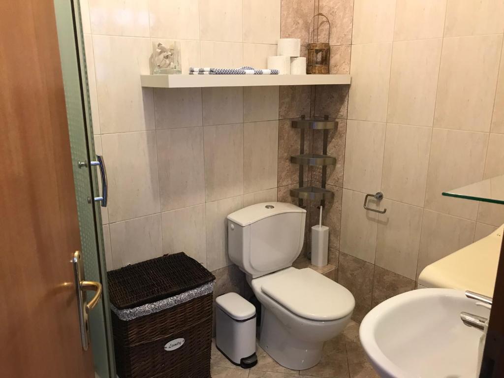 a small bathroom with a toilet and a sink at Kali Stalonia in Nikiti