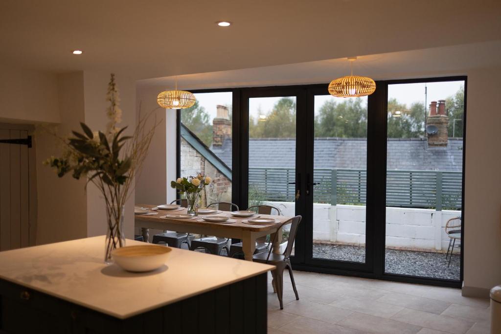 a dining room with a table and a view of a balcony at Cosy Country Townhouse in Woodstock in Woodstock