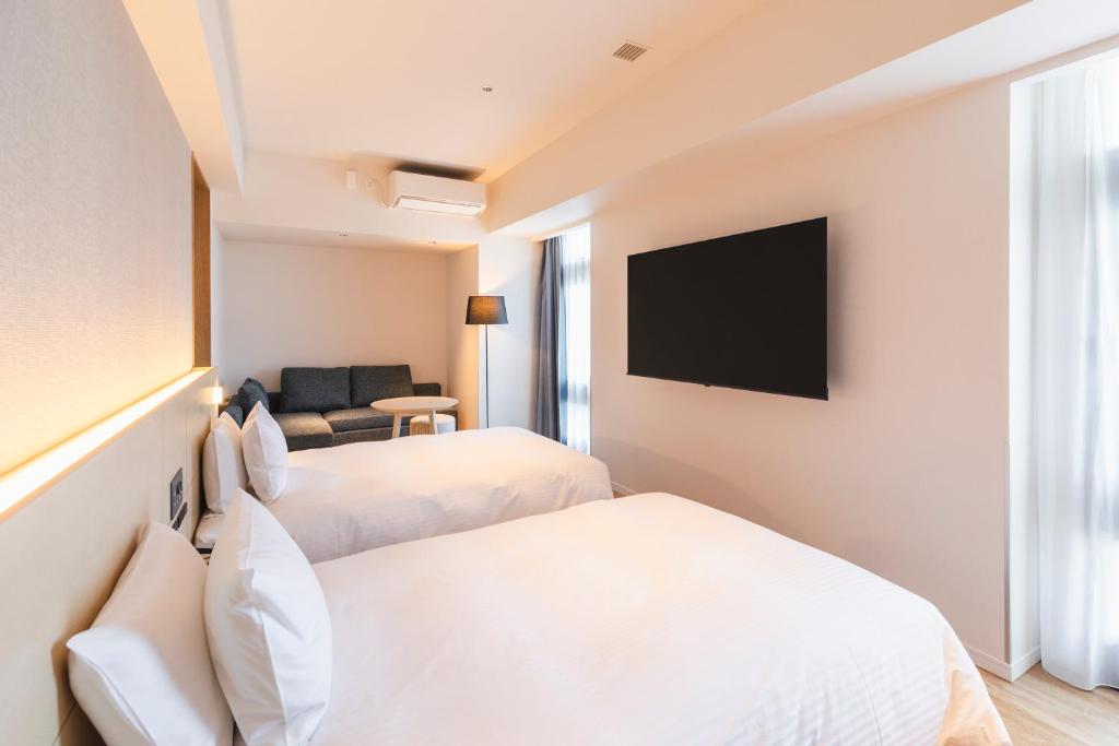 Postel nebo postele na pokoji v ubytování Sotetsu Hotels The Splaisir Yokohama