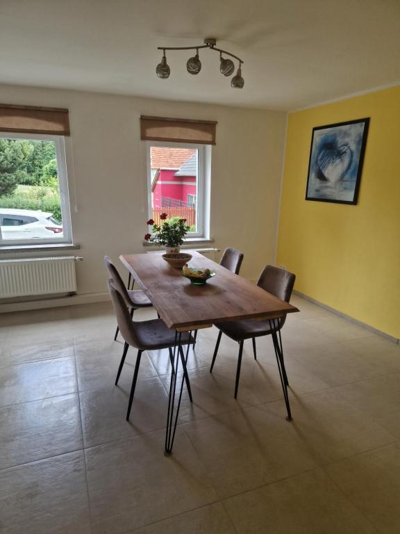 a dining room with a wooden table and chairs at Ferienhaus in Burgenlandkreis (Osterfeld) in Osterfeld