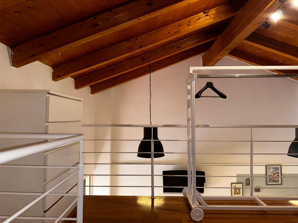a kitchen with wooden ceilings and a hanging light at Casa di Nia Pietralata in Rome