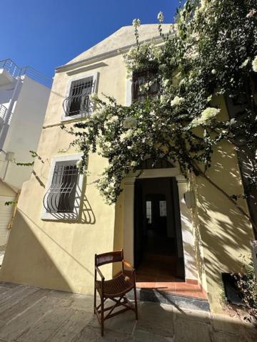 a chair sitting in front of a building at Old Town Traditional House in Kos Town