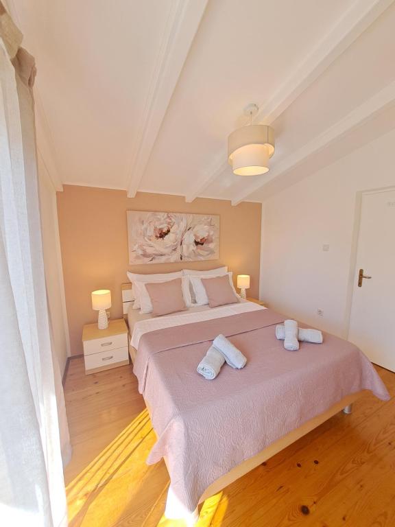Postel nebo postele na pokoji v ubytování Apartments Nicole