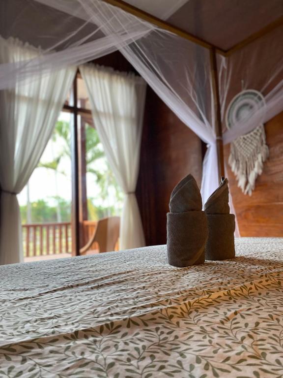Postel nebo postele na pokoji v ubytování Nuna Bungalows