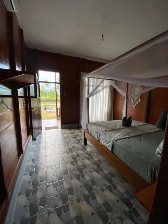 Postel nebo postele na pokoji v ubytování Nuna Bungalows