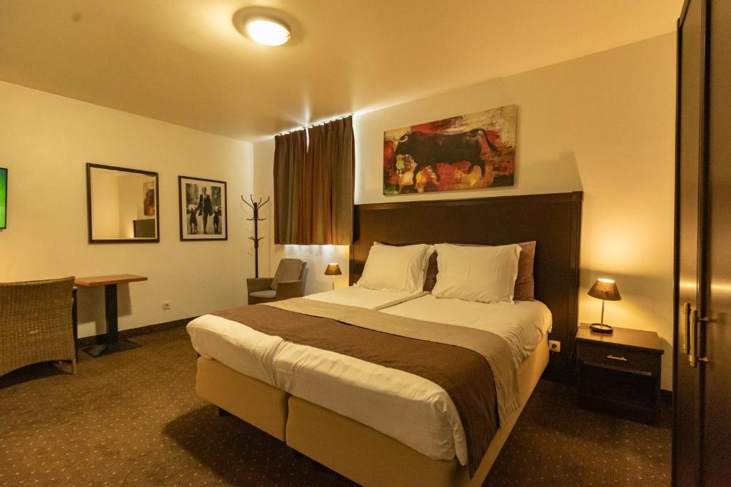 Postel nebo postele na pokoji v ubytování Hotel Malon