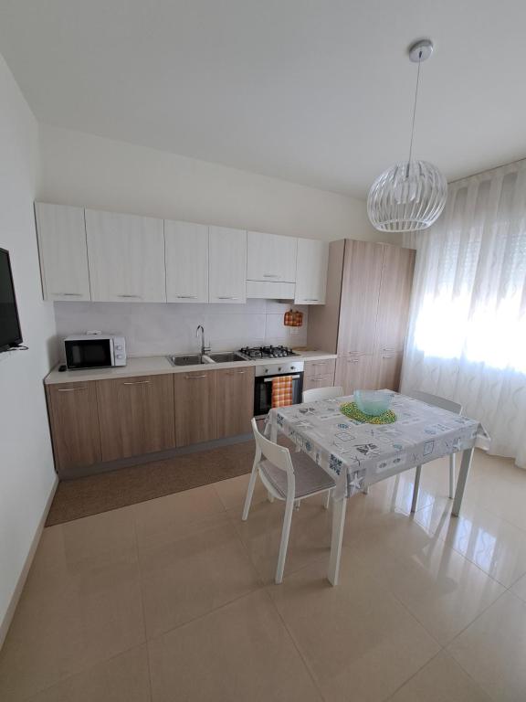 a kitchen with a table and a dining room at Casa Ely in Sottomarina