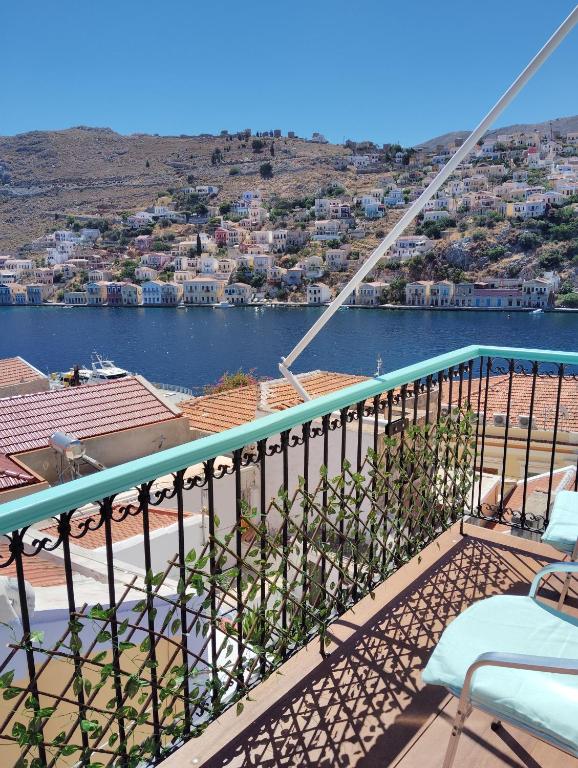 a balcony with a view of a body of water at 89 Steps Symi in Symi