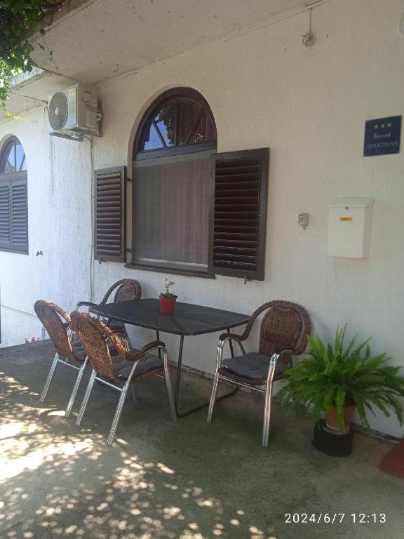 a table and chairs sitting in front of a building at Room Nena in Senj