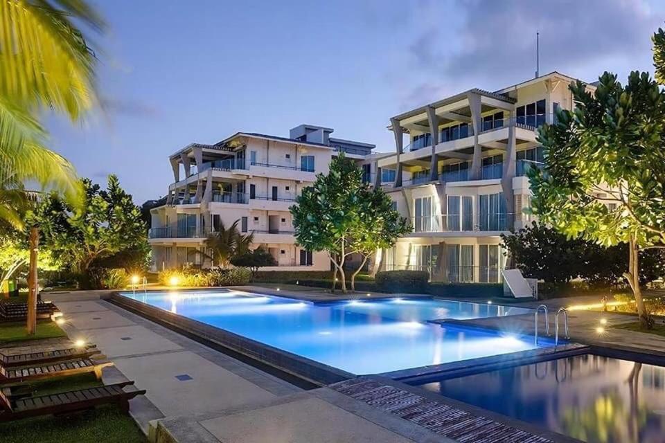 a large swimming pool in front of a building at Pearl Of Ocean Front in Trincomalee