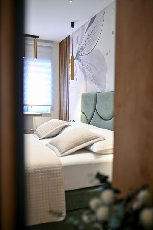 Posteľ alebo postele v izbe v ubytovaní Apartments and Rooms Nekic