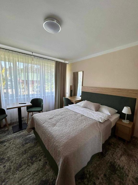 Postel nebo postele na pokoji v ubytování Zem-Tourist
